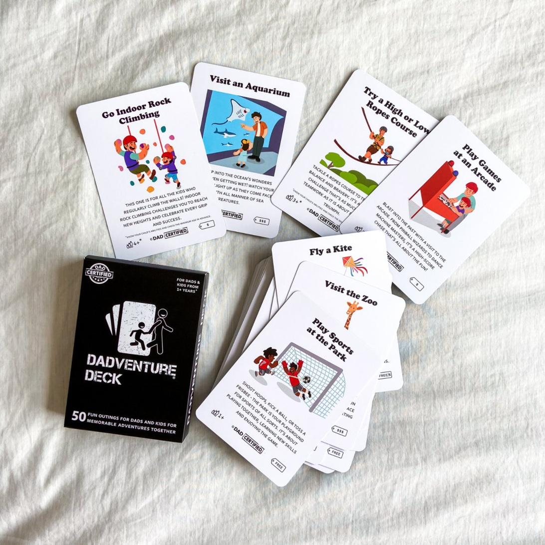 The Dadventure Deck box with its illustrated activity cards laid out and spread around it
